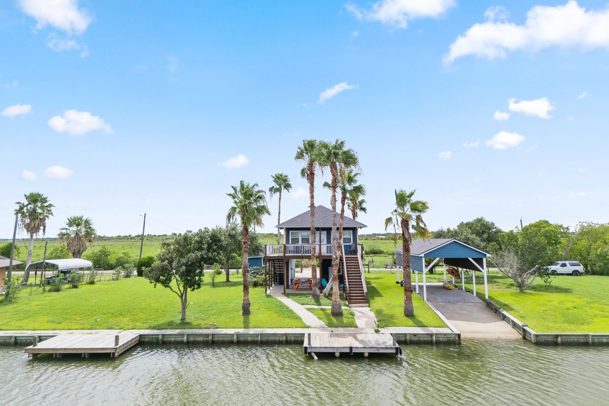 Backyard view of home and boat ramp
