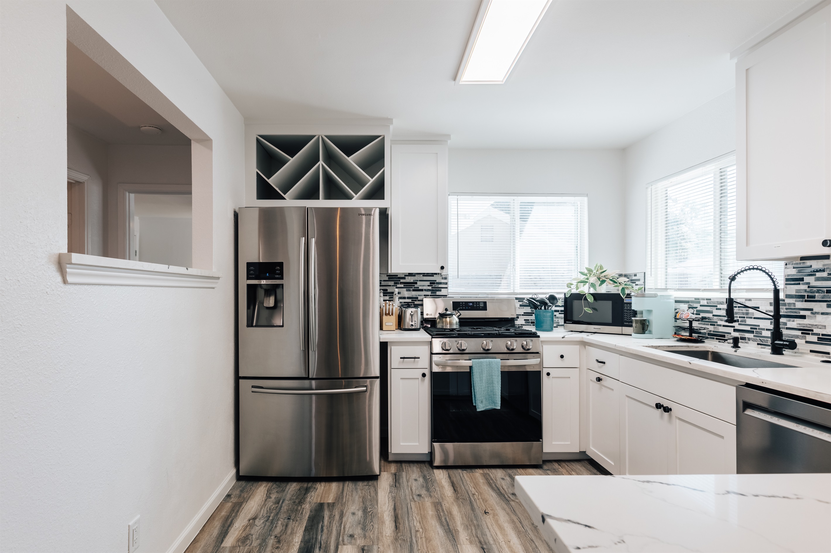Modern layout with ample counter space and storage, coffee, oven, big frig, ice maker