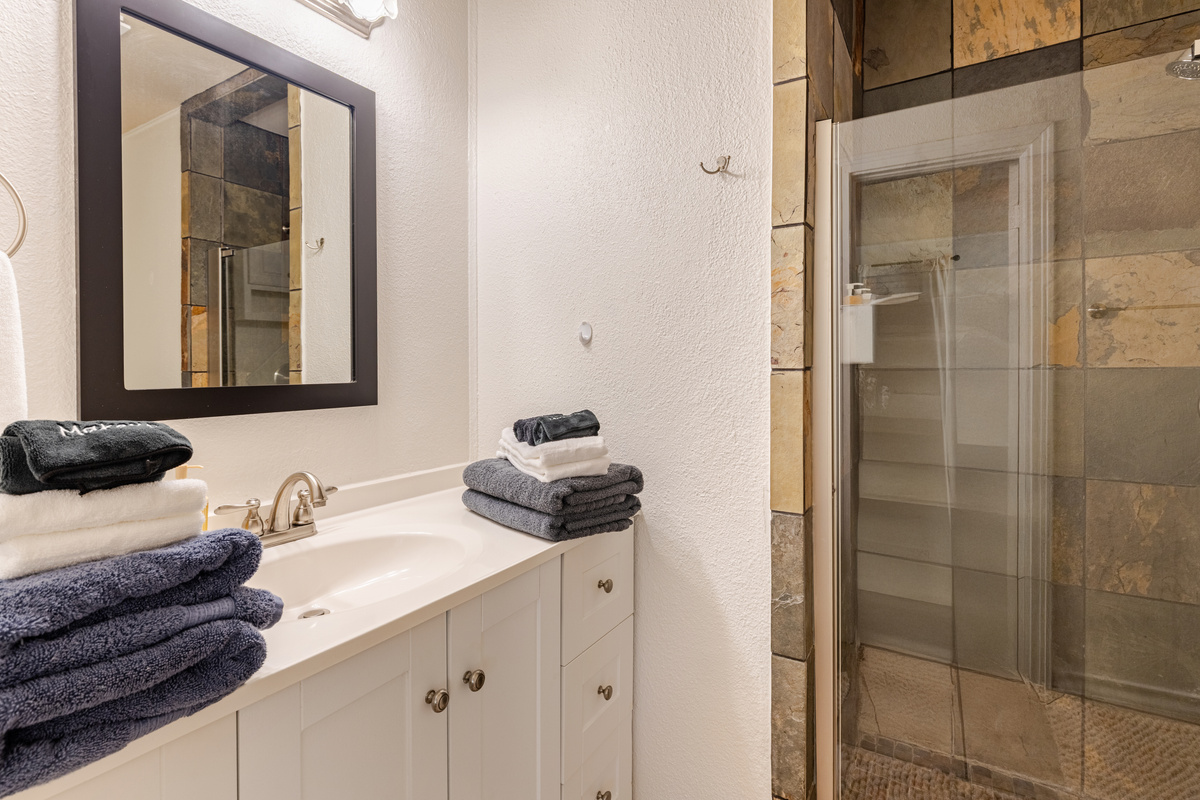 Enjoy spacious elegance with stylish tiles and plush towels at your fingertips!