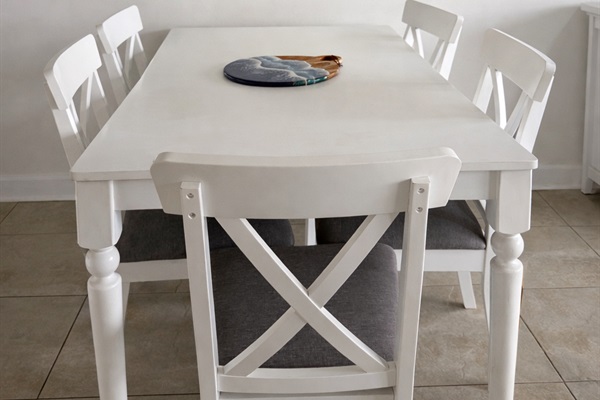 Bright coastal dining area with seating for six
