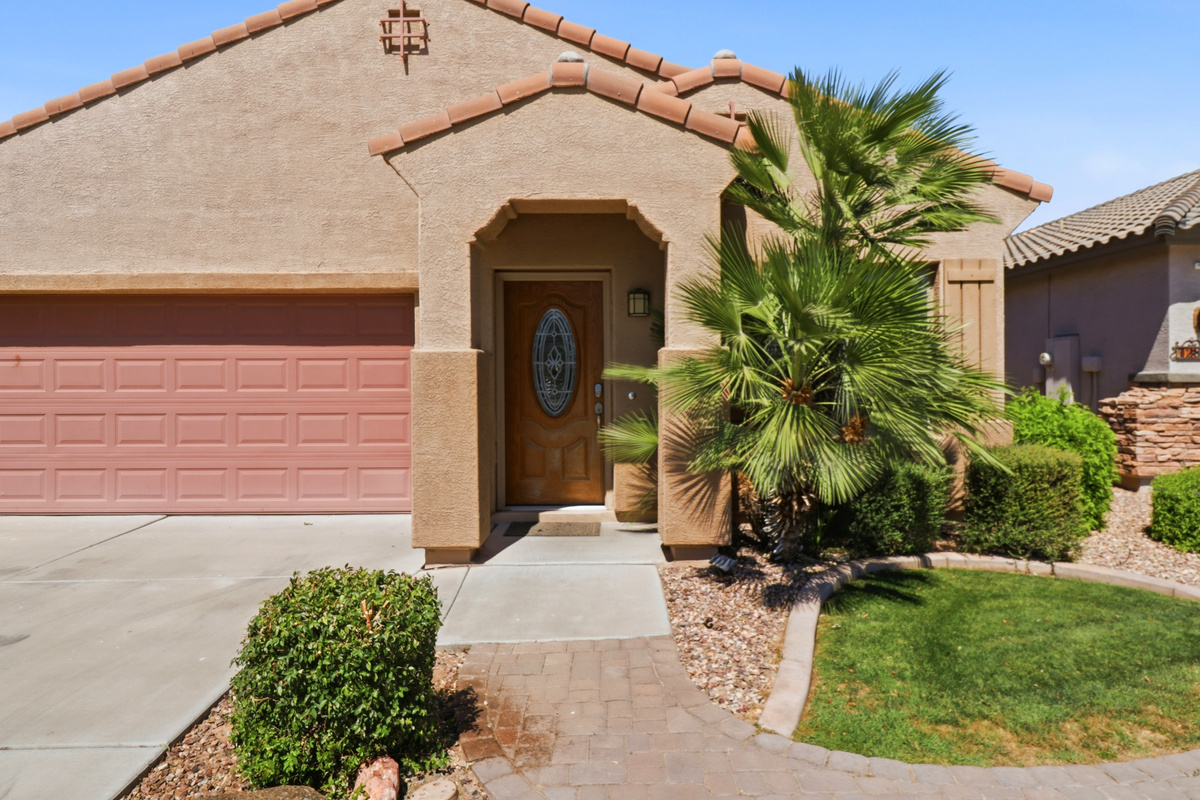 Private entrance with garage access, front walkway, and a simple arrival path into the home.

