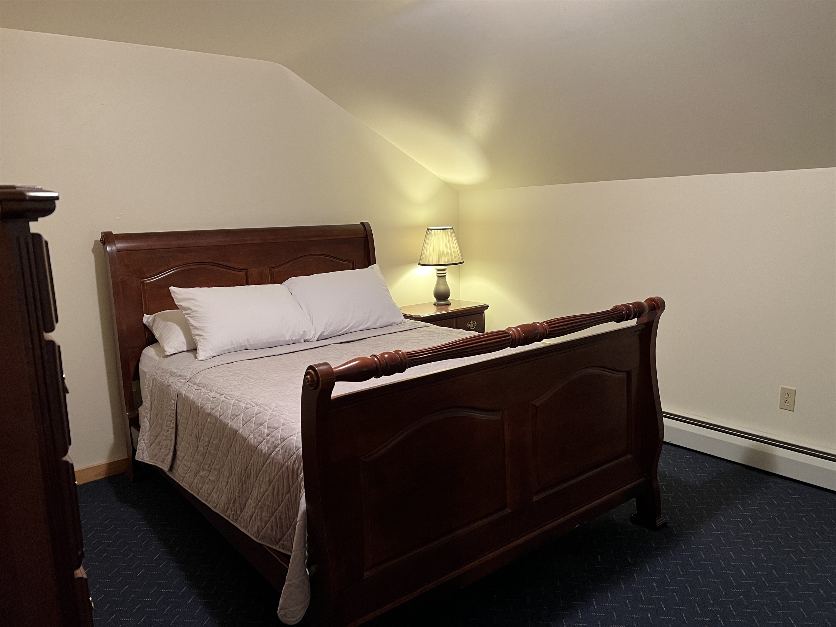 Queen bedroom with sleigh bed.