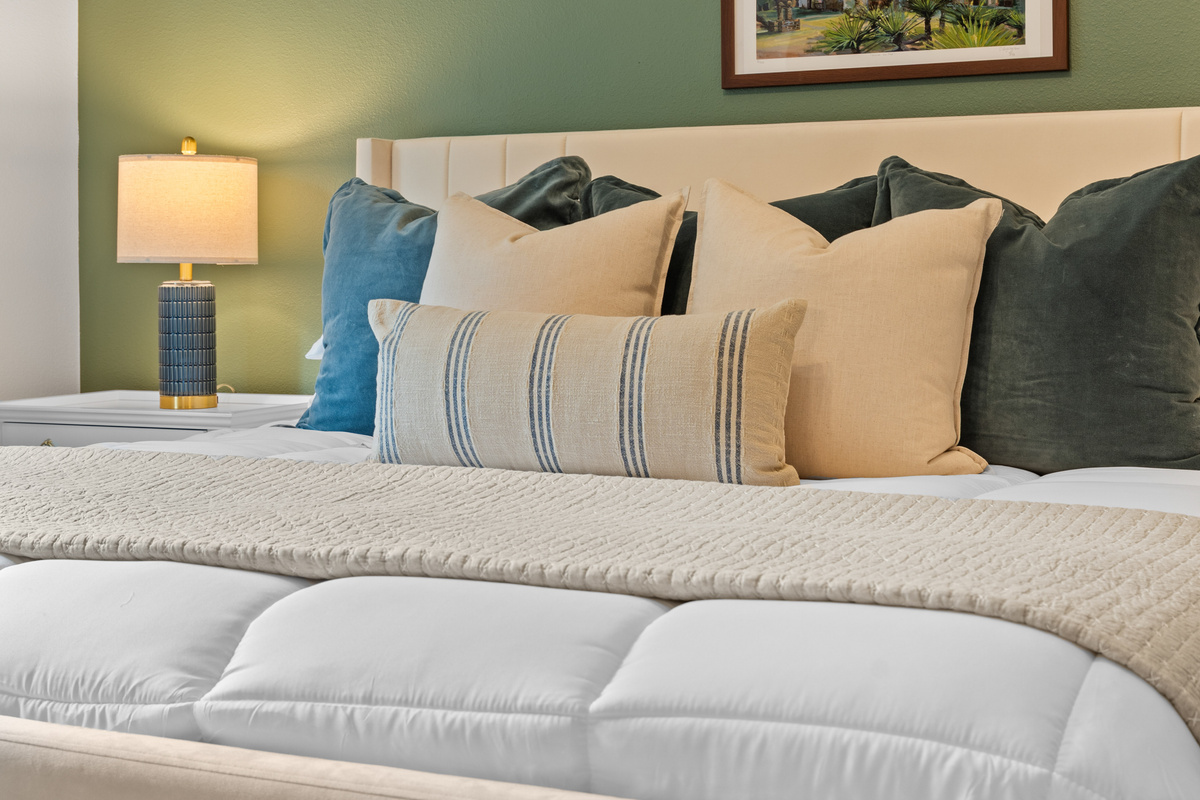 Layered linens and mission-inspired art bring quiet Texas charm to the San Antonio king bed.