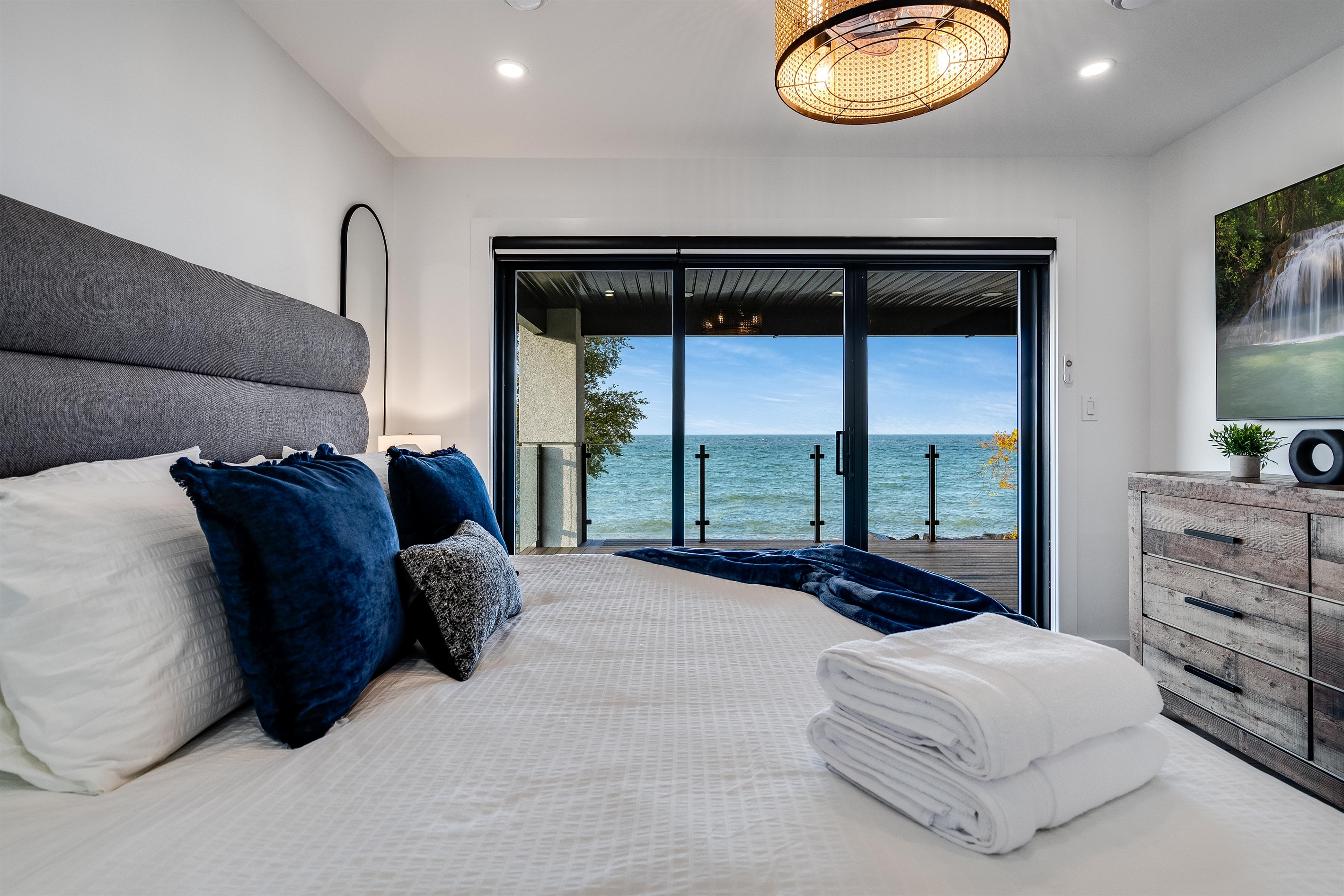King Bedroom with Blue pillows pop against neutral bedding.