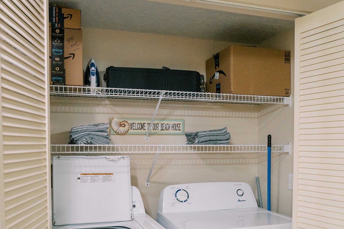 Pack 'n' Play storage above full-sized washer/dryer.