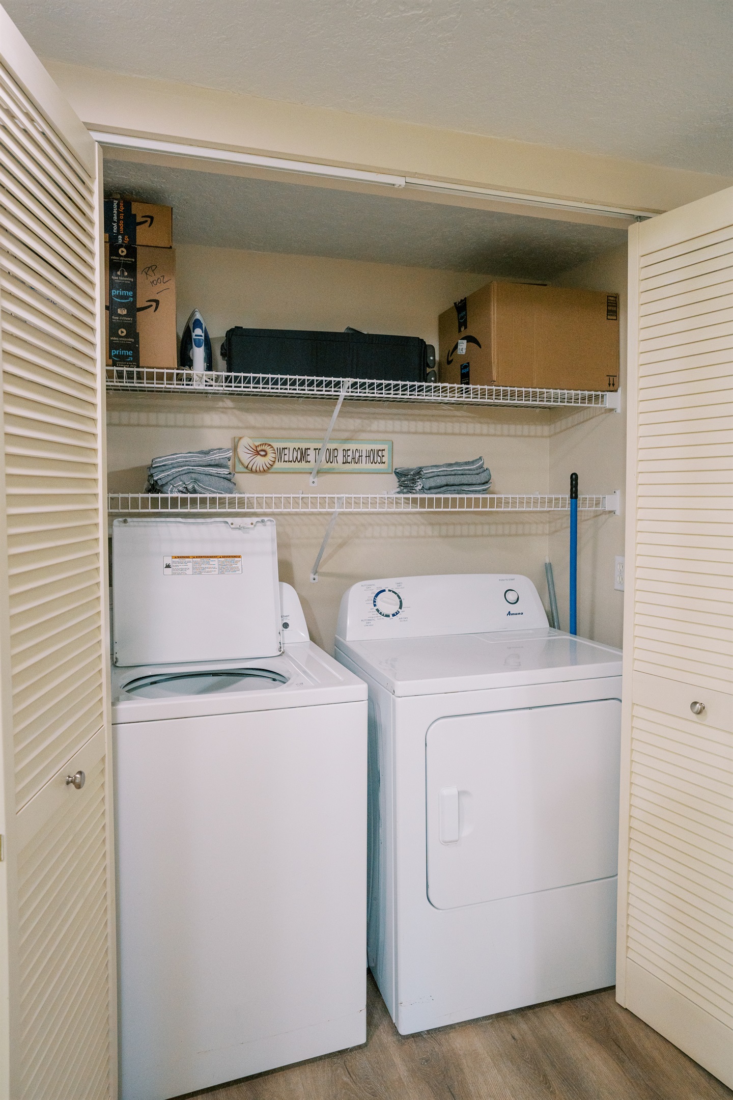 Pack 'n' Play storage above full-sized washer/dryer.