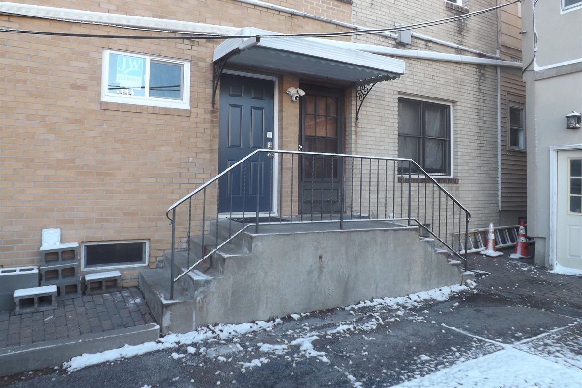 Entrance is on the side of the building. Use the door on the left.