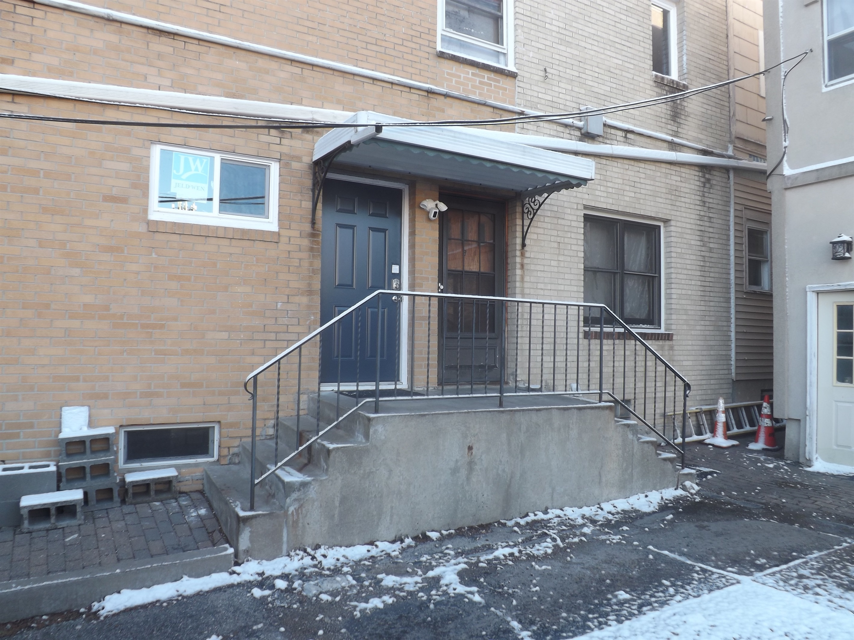 Entrance is on the side of the building. Use the door on the left.