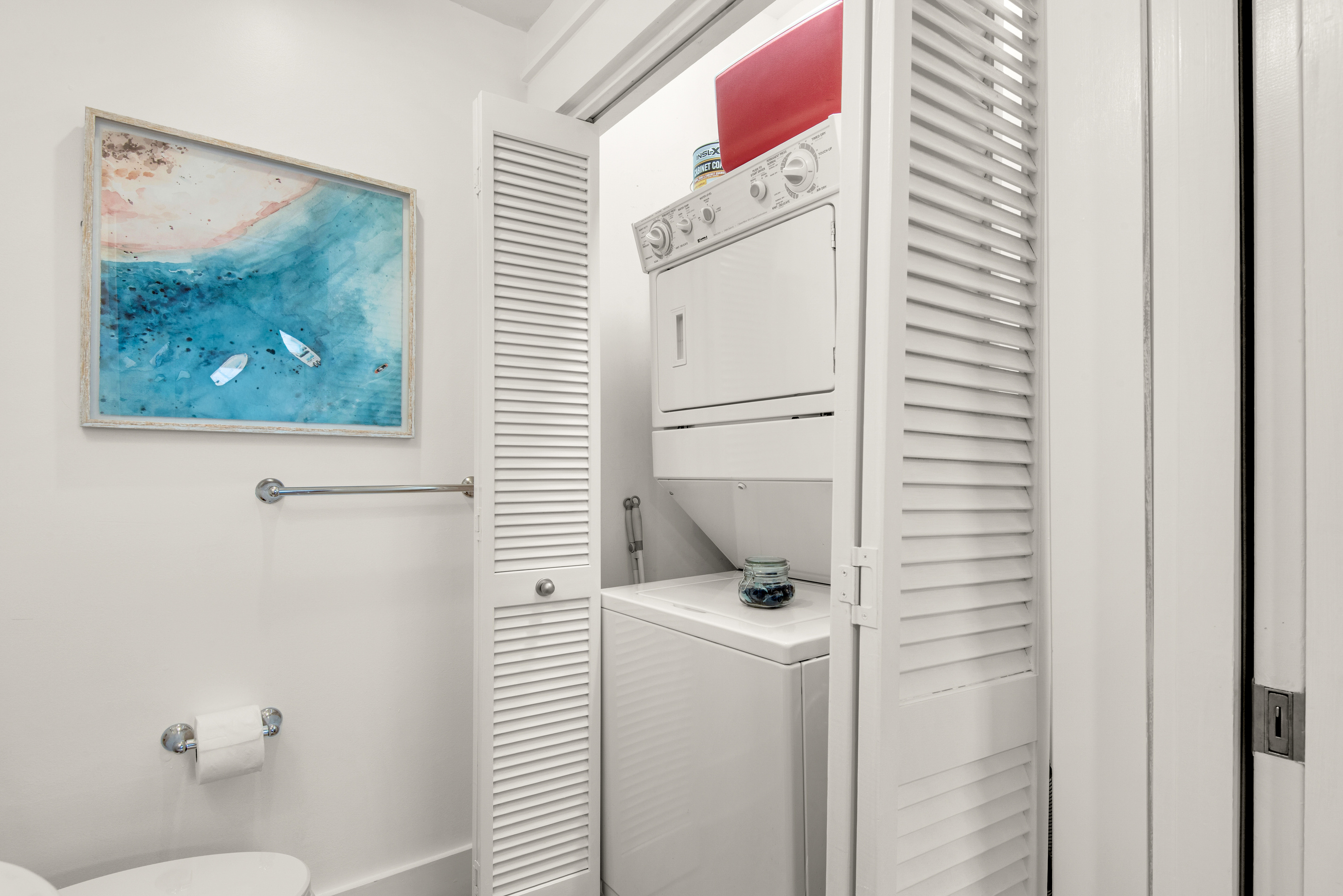 Stacked washer and dryer inside the laundry closet at Seagrove Bungalow 103.