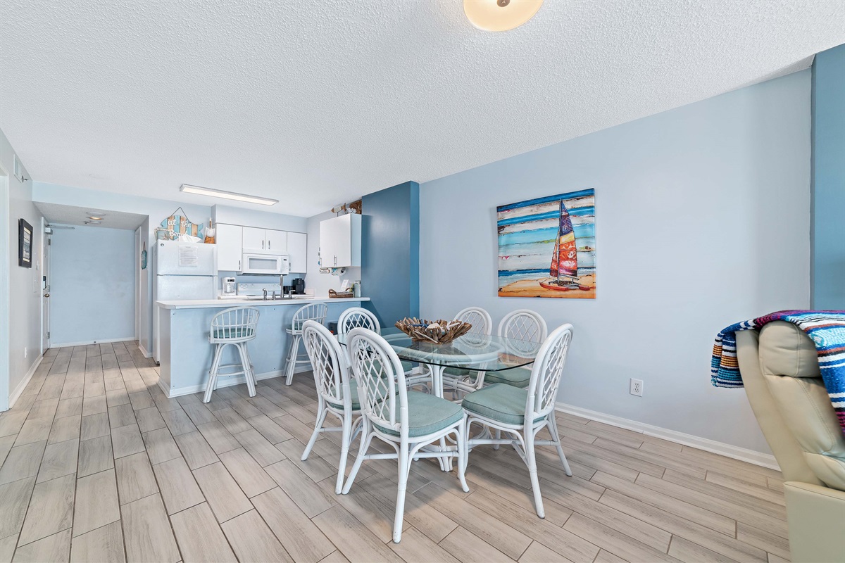 A comfortable living room with ample seating, flowing into a dining area, ideal for everyday living and gatherings.