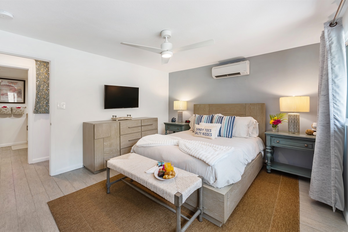 Primary bedroom with King bed, ceiling fan and ensuite bathroom. 