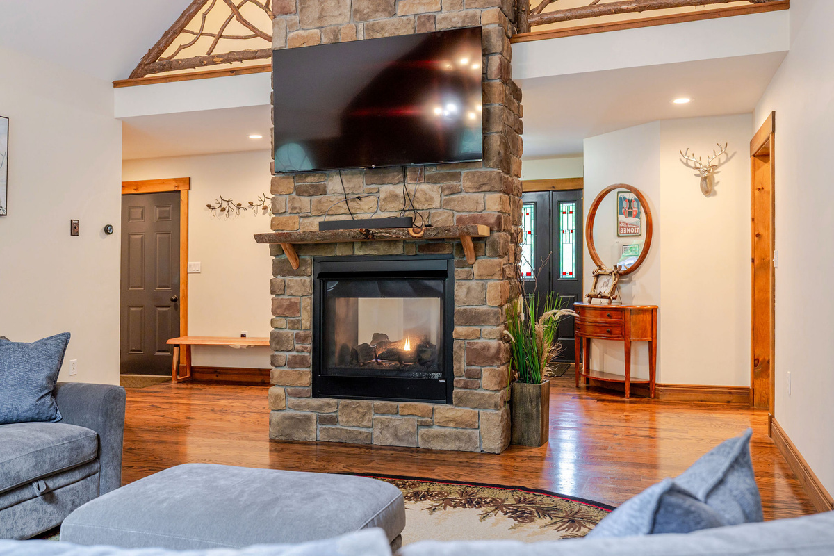 A beautiful stone fireplace anchors the great room, creating a warm and inviting space for relaxing with family and friends.