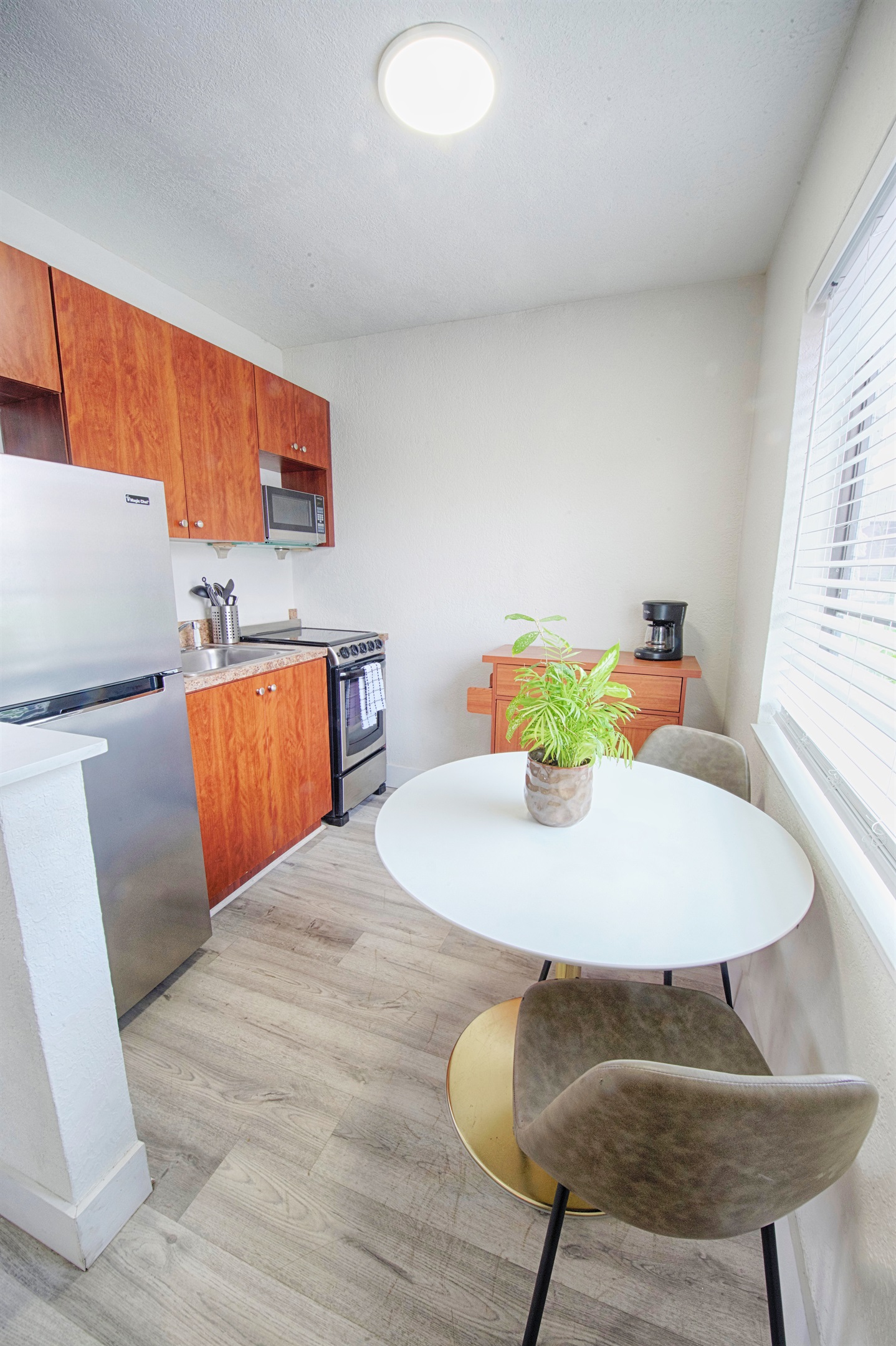 Kitchen with dining table and kitchen cart.