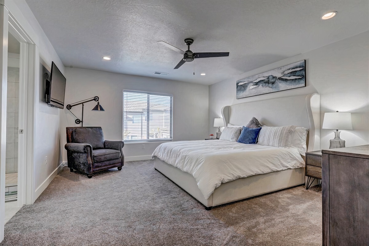 Large master bedroom with a California king-sized bed.