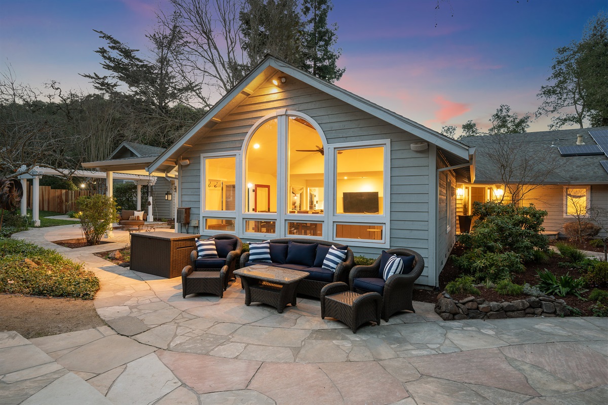There are 5 separate seating areas around the property. Just outside the living room, this comfy couch and set of 2 lounge chairs overlooks the pool.