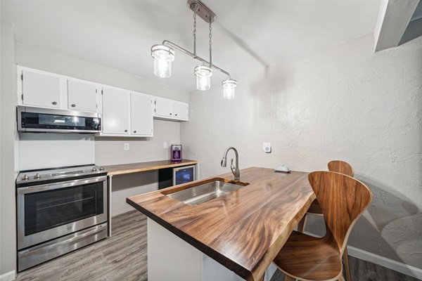 The spacious kitchen island with bar stools.