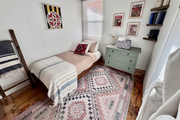 Both downstairs bedrooms have smart TVs and are bathed in natural light.  Appx 8’x9’. This room features an full en suite bathroom and a brand new bed and Casper twin size mattress (Feb 2026).