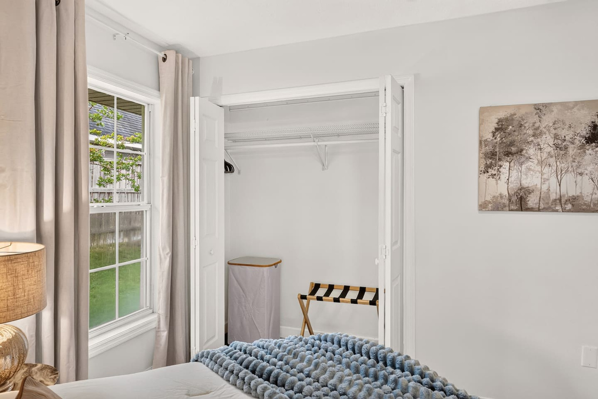 Plenty of closet space with a luggage rack and hamper for guest use.