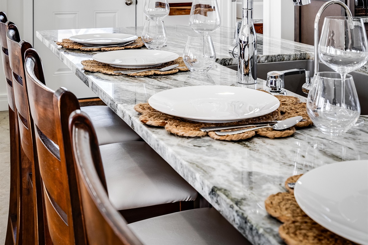  White walls shimmer like morning light, grounded by wood’s steady embrace.