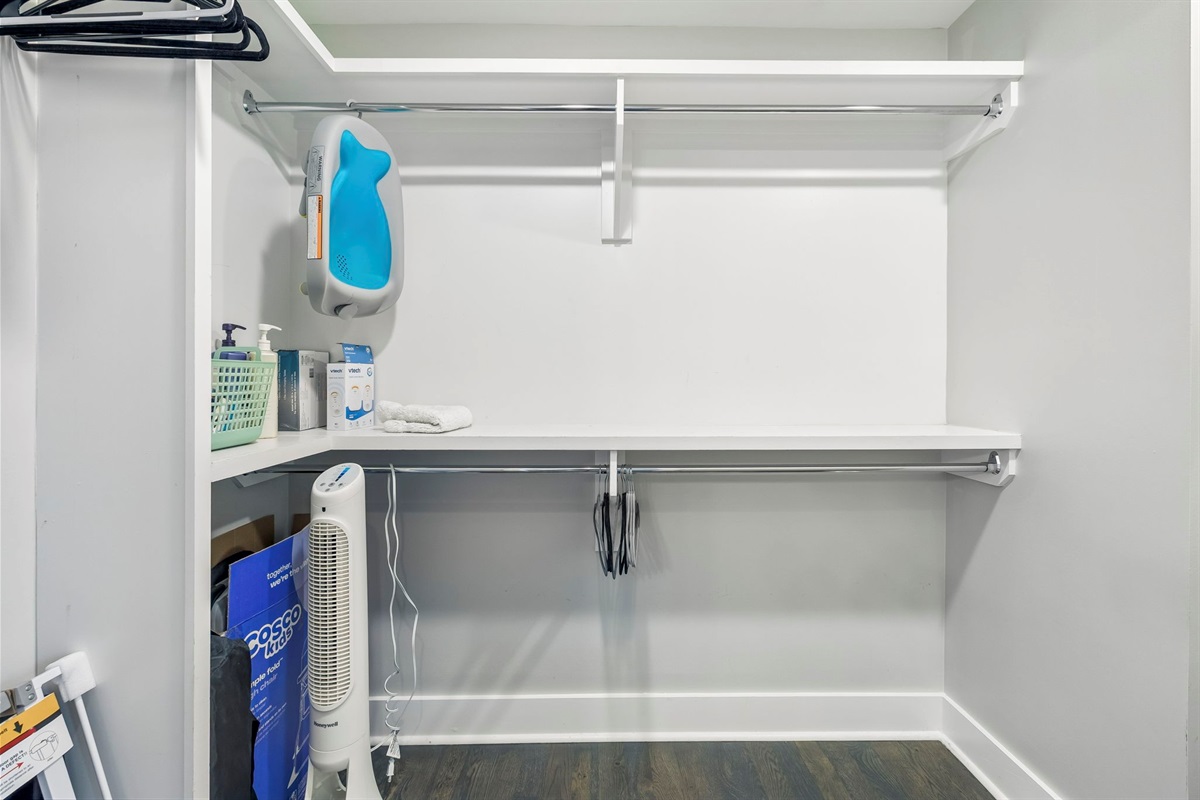 Generous shelving and dual hanging rods provide extra space for all your belongings - Clean white finishes and wood flooring create a crisp, organized storage area - Ideal for longer stays, offering plenty of room for suitcases, shoes, and wardrobe