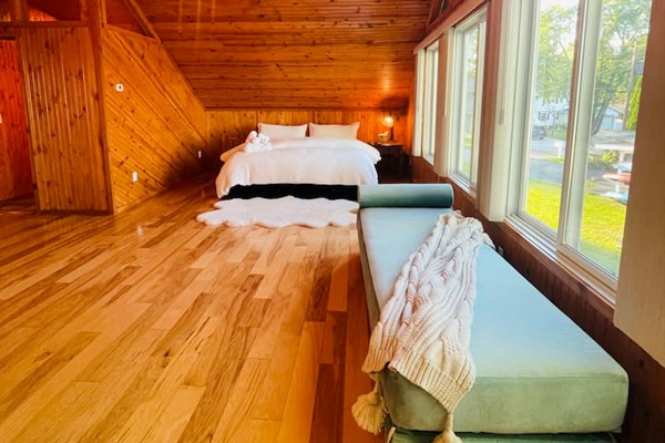 Spacious bedroom with wood interior and peaceful cabin atmosphere.