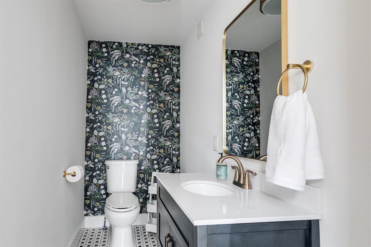 1st Floor Powder Room: Stylish floral wallpaper and modern fixtures for a refreshing touch!