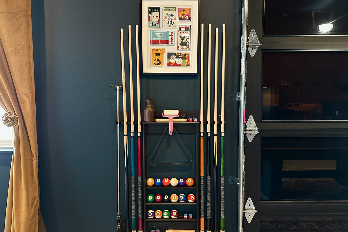 Cues, chalk, darts and a full rack of balls — everything's racked and ready when you are.