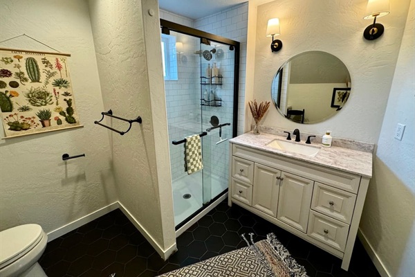 This master bathroom features a clawfoot soaking tub and shower for a relaxing bathing experience.