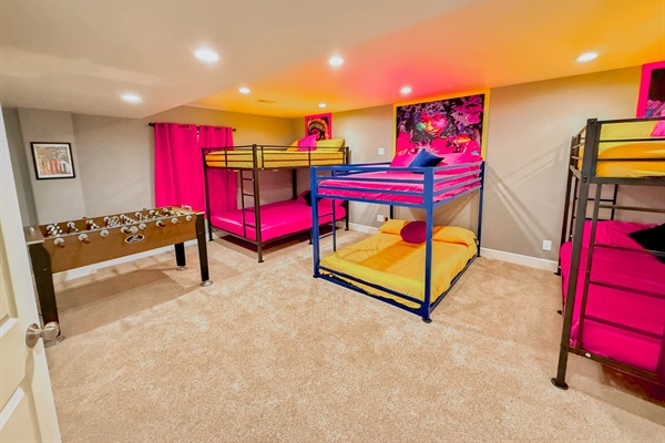 Bunk Bedroom: Spacious and fun, featuring cozy bunk beds and a foosball table for entertainment.