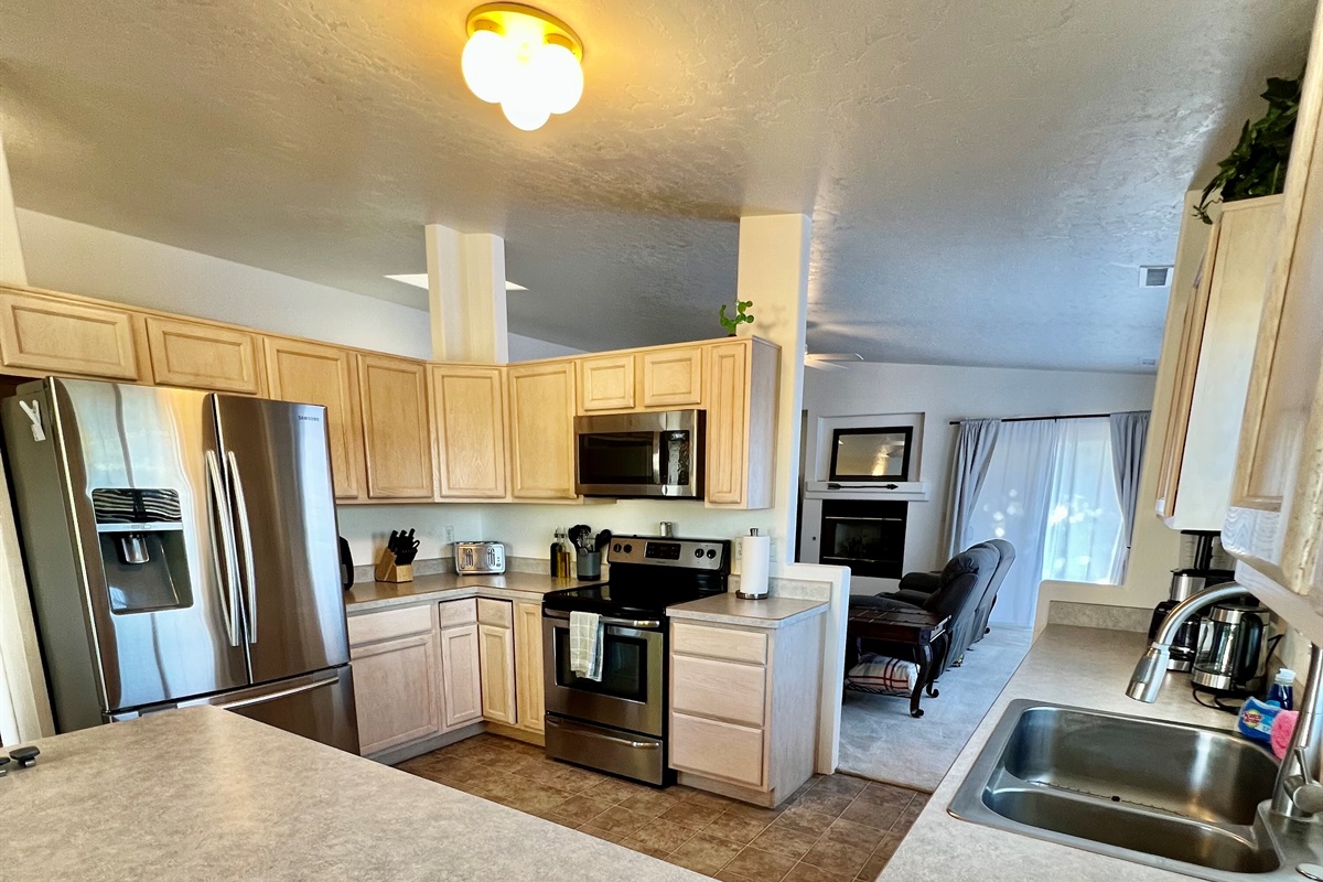 The spacious kitchen boasts ample counter space, stainless steel appliances, and all the essentials you need to whip up a gourmet meal with ease.