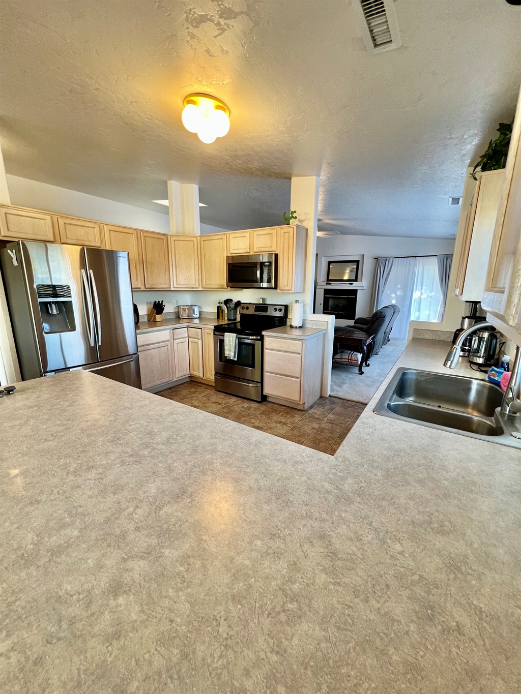 The spacious kitchen boasts ample counter space, stainless steel appliances, and all the essentials you need to whip up a gourmet meal with ease.
