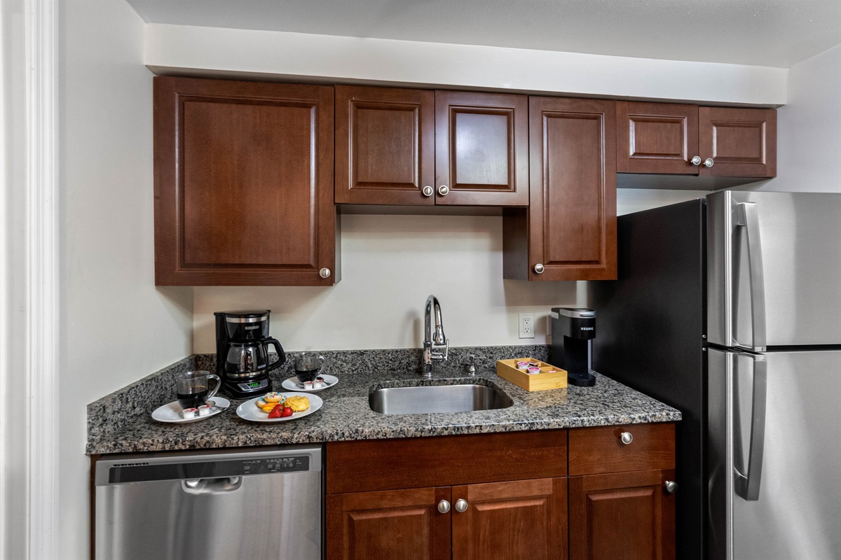A Keurig coffee maker and basic kitchen essentials are thoughtfully placed for your morning routine or quick beverage breaks.