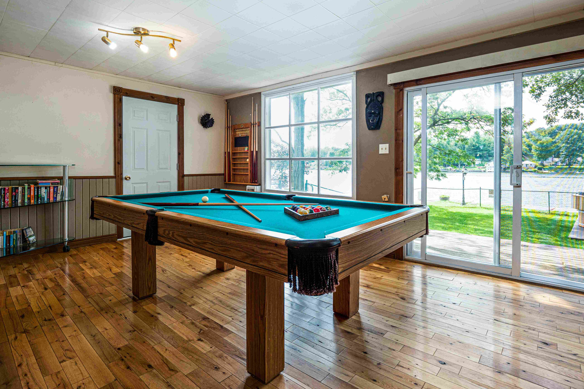 Recreation area with pool table and large windows