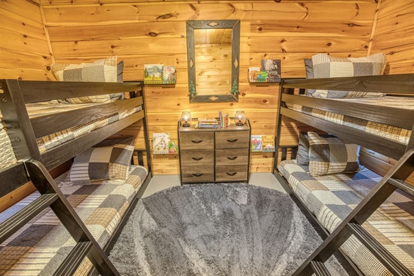 Basement bedroom with 2 bunkbeds, each with 2 twin beds (4 total twin beds) - great for kids! Includes kids' books, reading corner and wall sensory toy. 