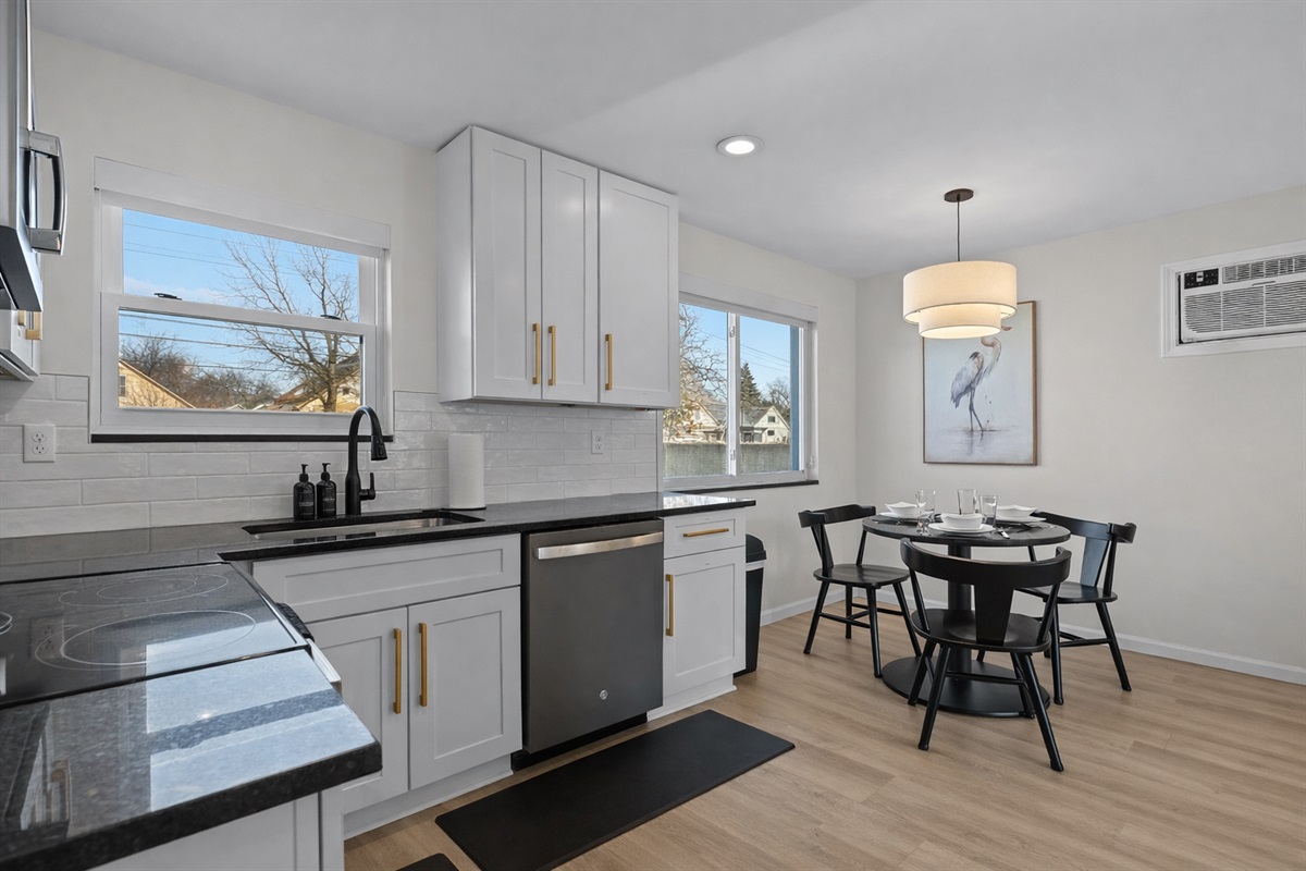 Bright kitchen and dining space with modern finishes, natural light, and seating for four—ideal for cooking, dining, and everyday comfort.