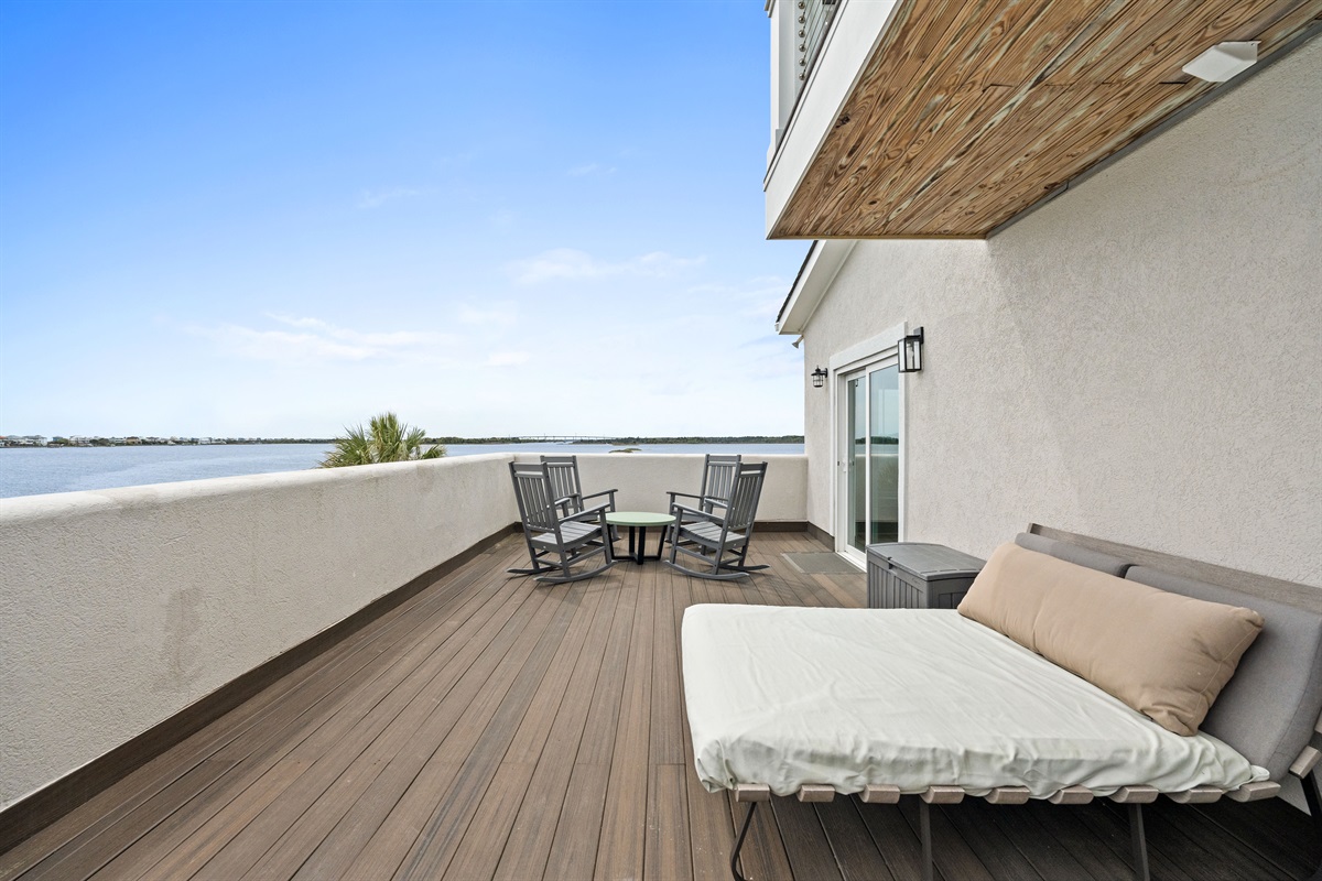 Relax outdoors with chaise lounge seating and rocking chairs overlooking the water