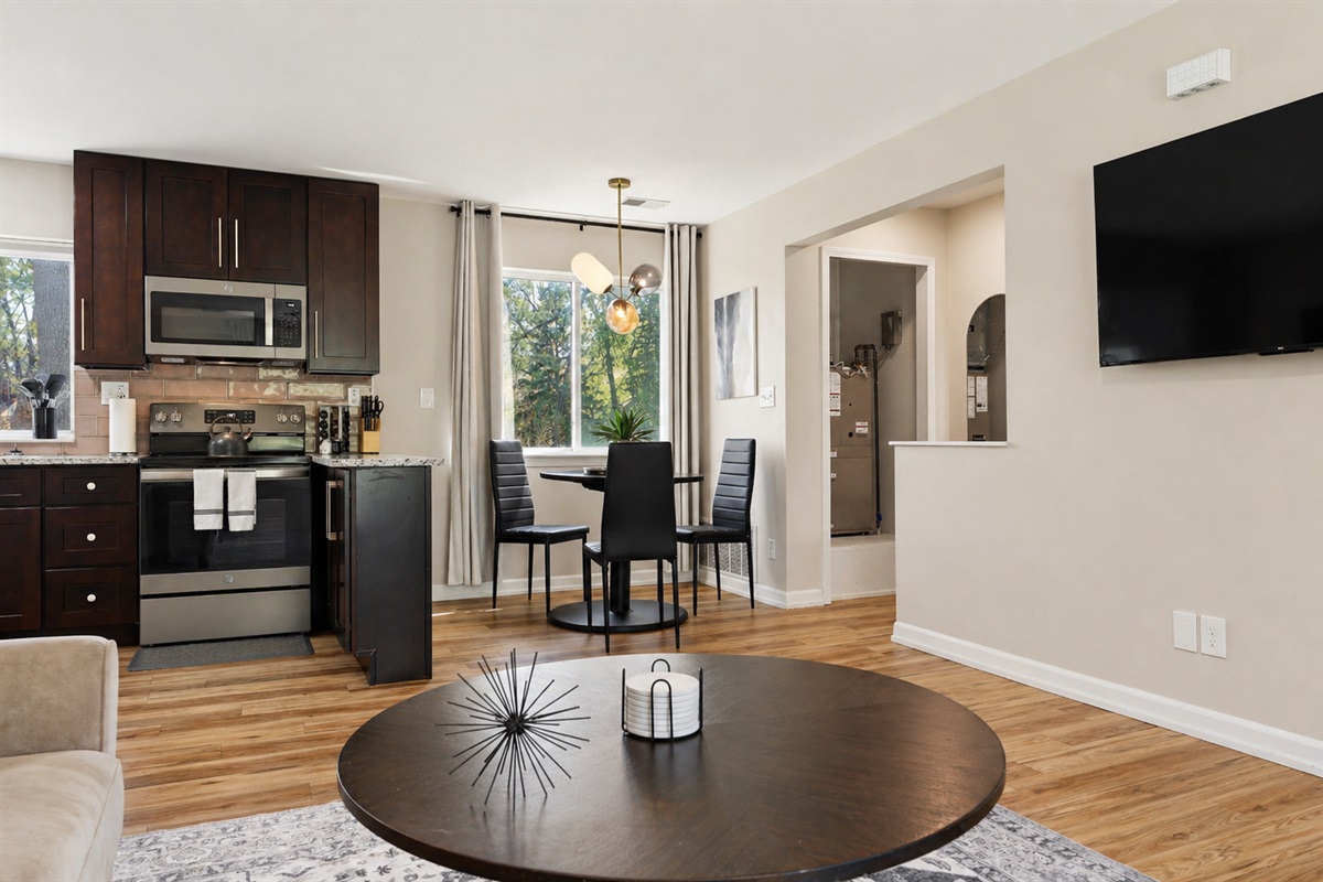 Open-concept living space with ample seating and a flat-screen TV.