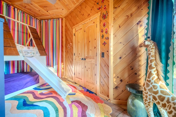 Kids room with bunk beds and slide