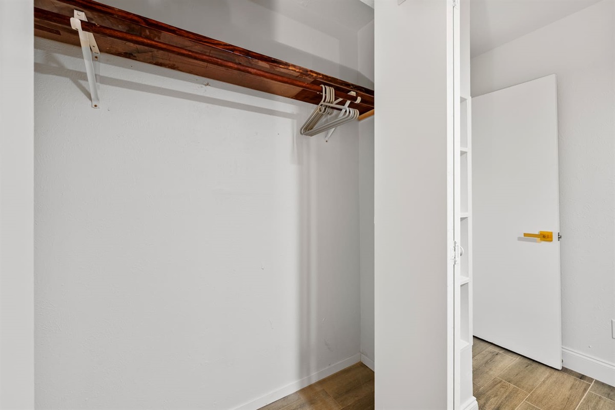 Spacious closet with hangers and built-in shelving—perfect for unpacking and staying organized during your stay.