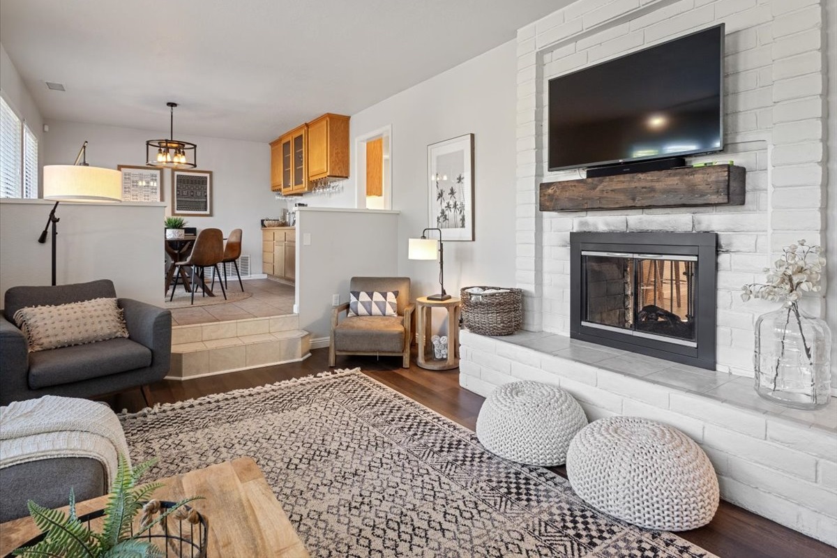 Sunken living room with double sided gas fireplace.