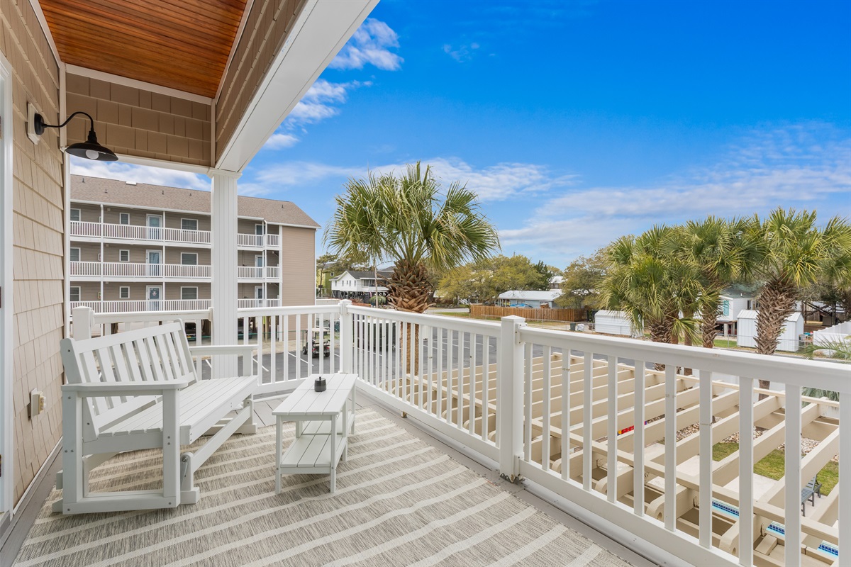 Watch the kids play in the pool below from the primary suite balcony on the main level