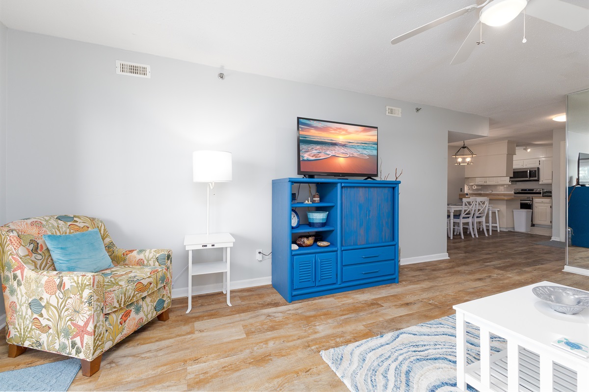 Cozy living room with TV, coffee table, couch, and stylish decor