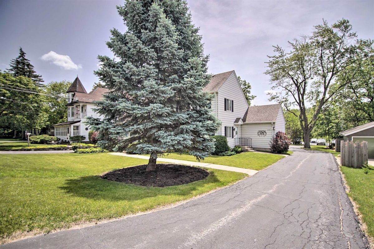 The front lawn is shown and the private driveway leads to the ample free parking in back. 