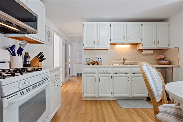 The kitchen and dining area unite as the heart of the home, where culinary dreams flourish and cherished moments are shared