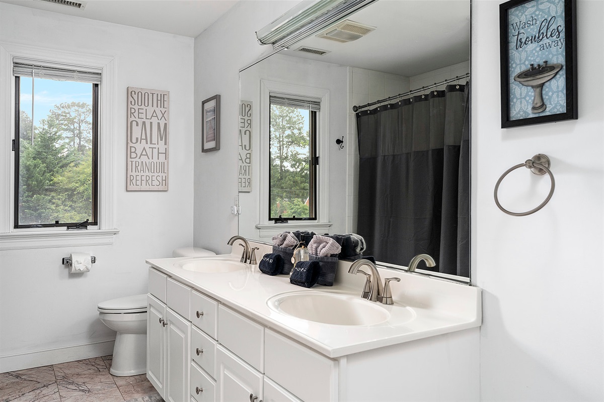 Full Bathroom 3: Bright and airy, with double sinks and serene views to wash your cares away!