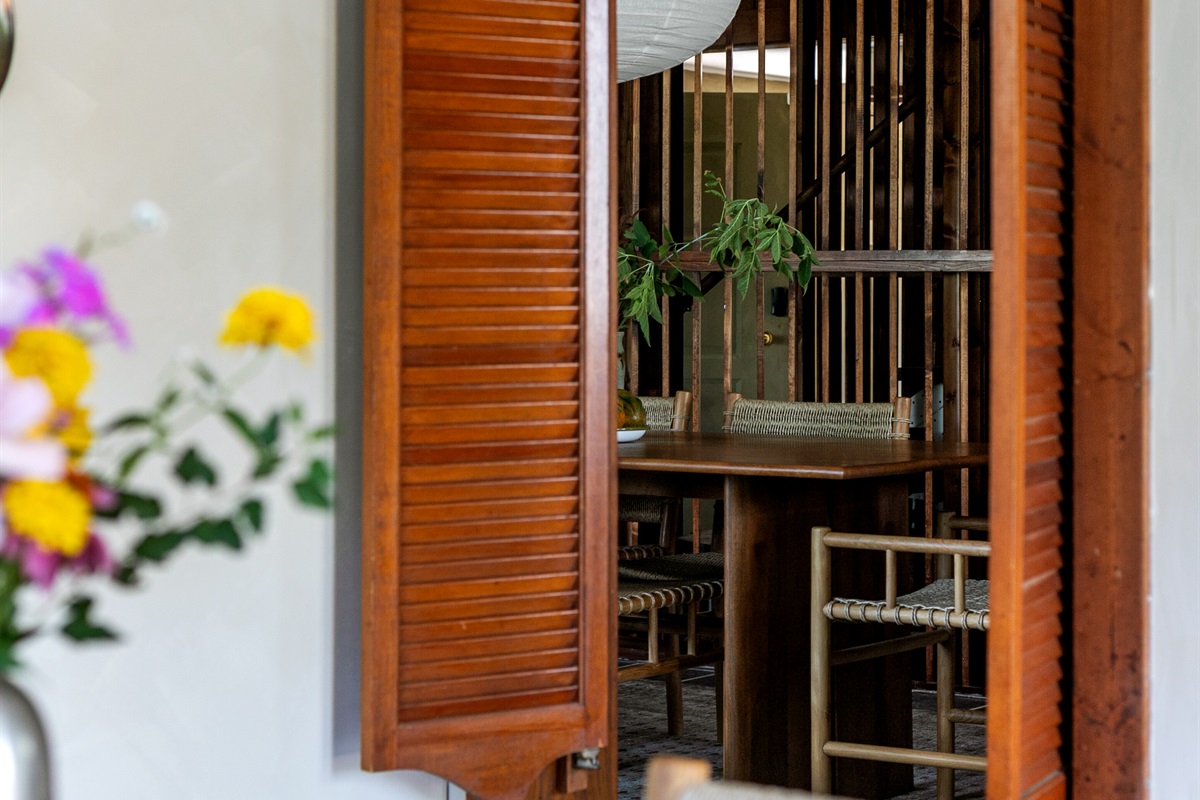 Charming swinging doors open into the breakfast nook, adding a touch of fun to the home’s modern design.