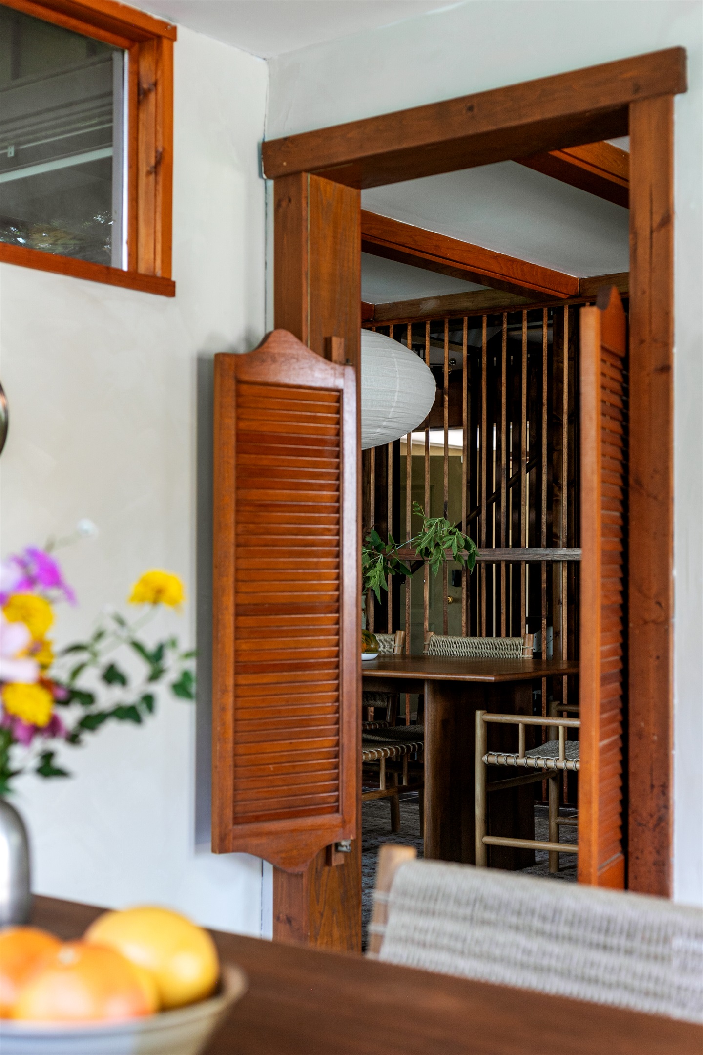 Charming swinging doors open into the breakfast nook, adding a touch of fun to the home’s modern design.