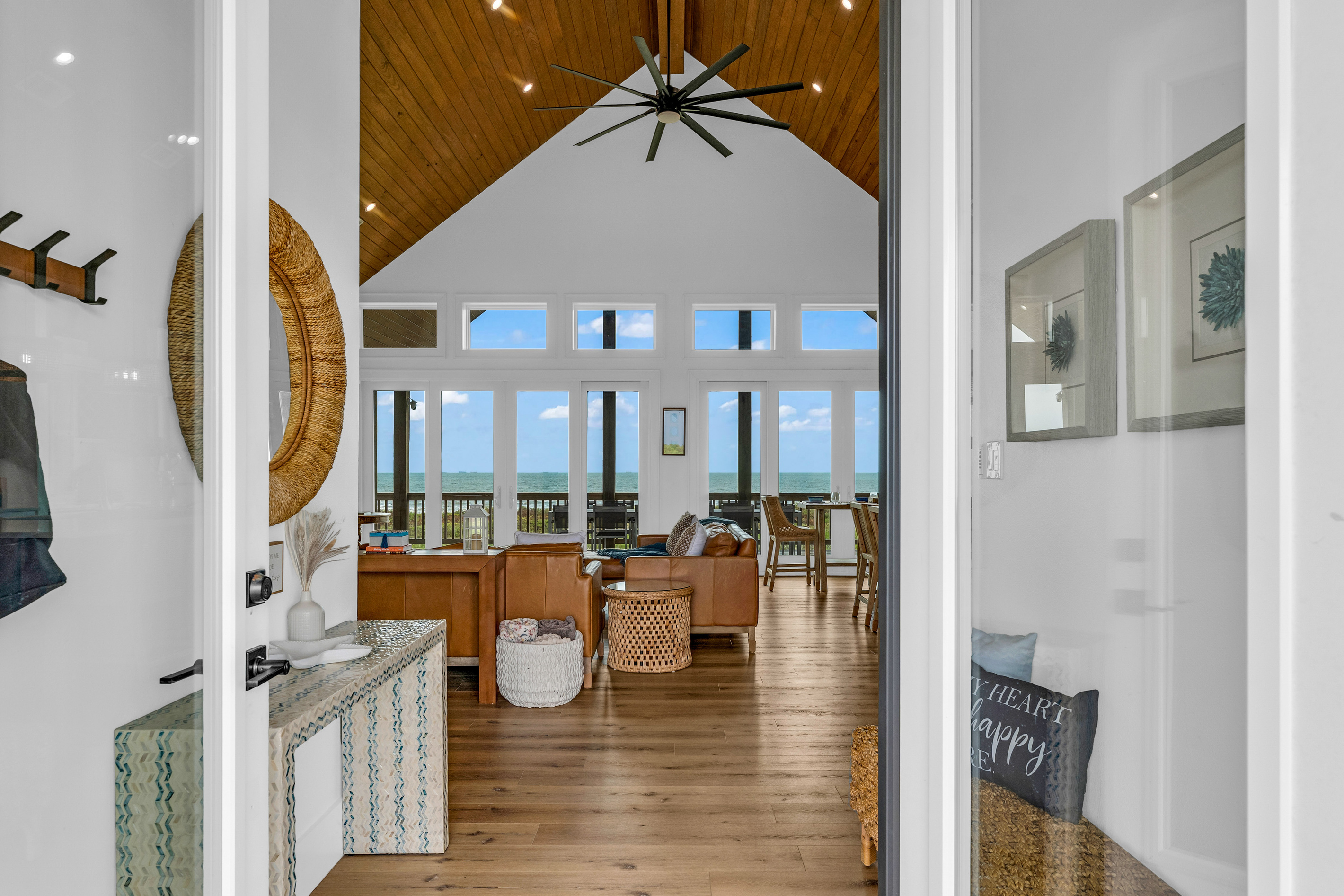 Welcome to Cair Paravel by HTH Stays, Step through the front door and the view does the talking, a straight sightline past the entry hall to the vaulted great room and the Gulf beyond.
