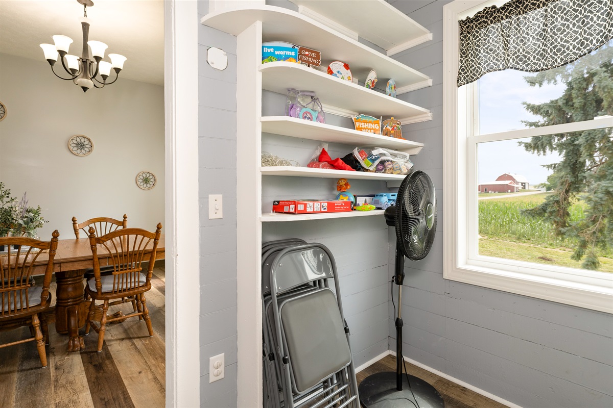 Charming built-in shelving stocked with classic board games and extra seating, perfect for family fun nights or hosting larger groups.
