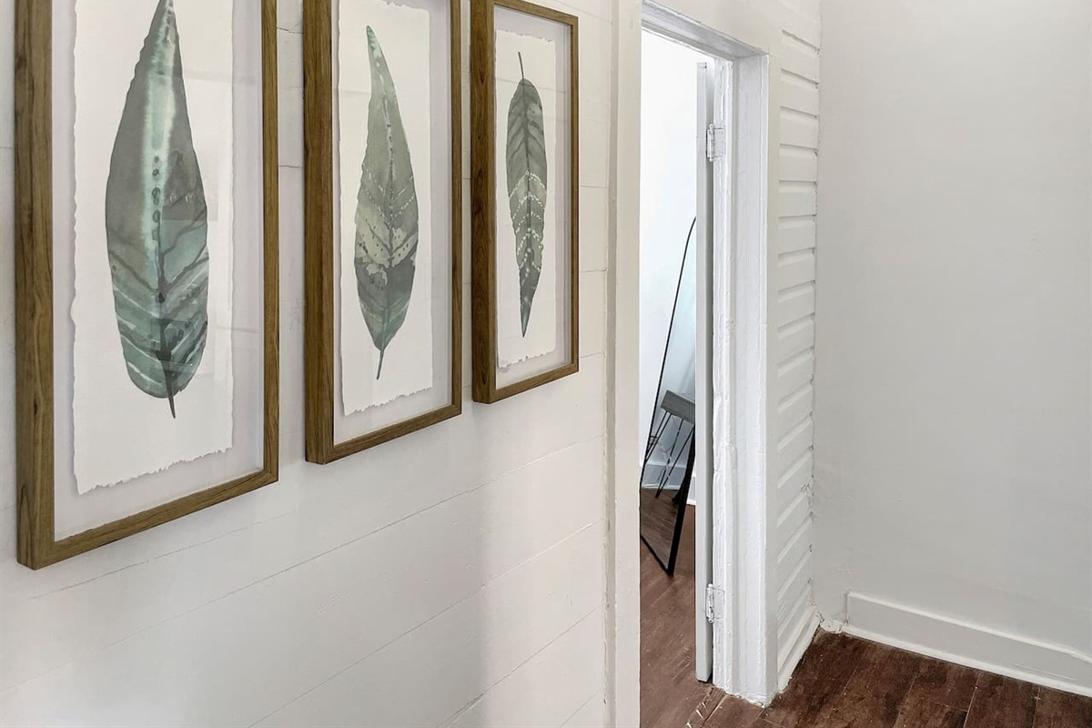 Relaxing art escorts you to the back bedroom and fully renovated shared bathroom.